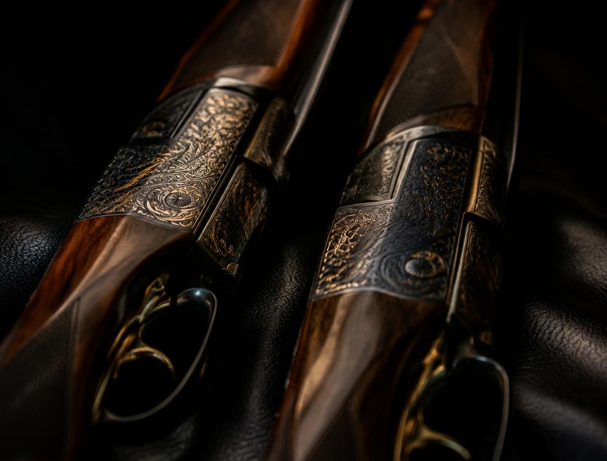 Two engraved shotgun receivers side by side